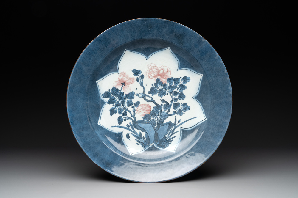 A Chinese blue, white and copper-red powder blue-ground 'peony' dish, Kangxi