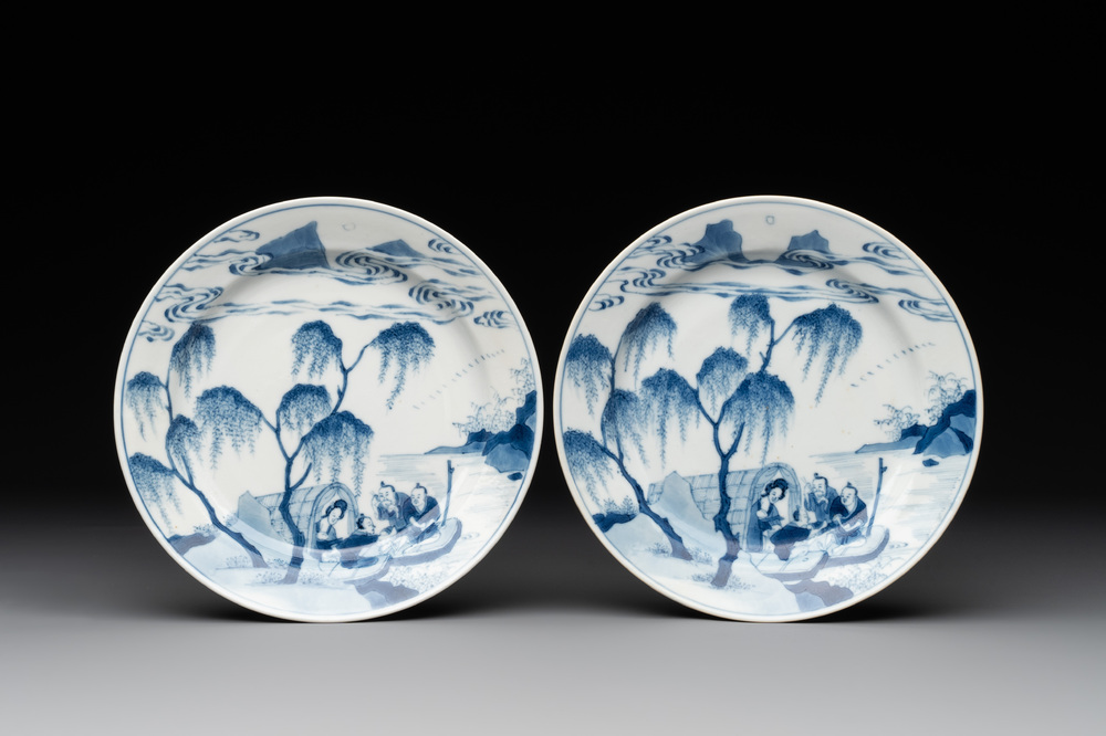 A pair of Chinese blue and white plates with a breastfeeding woman and fishermen on boats, Chenghua mark, Kangxi