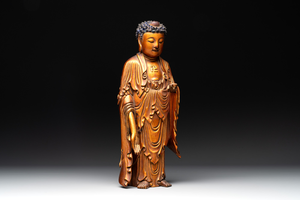 A fine Chinese gilt-lacquered wooden figure of the standing Buddha, Ming
