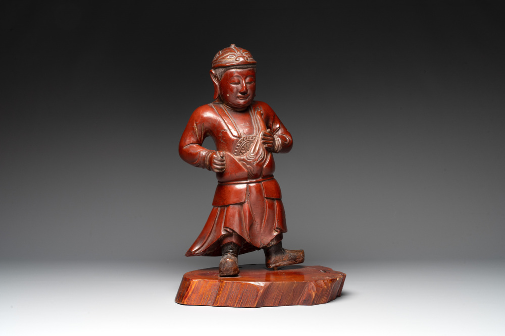 A Japanese lacquered wooden figure of a guardian, 19th C.