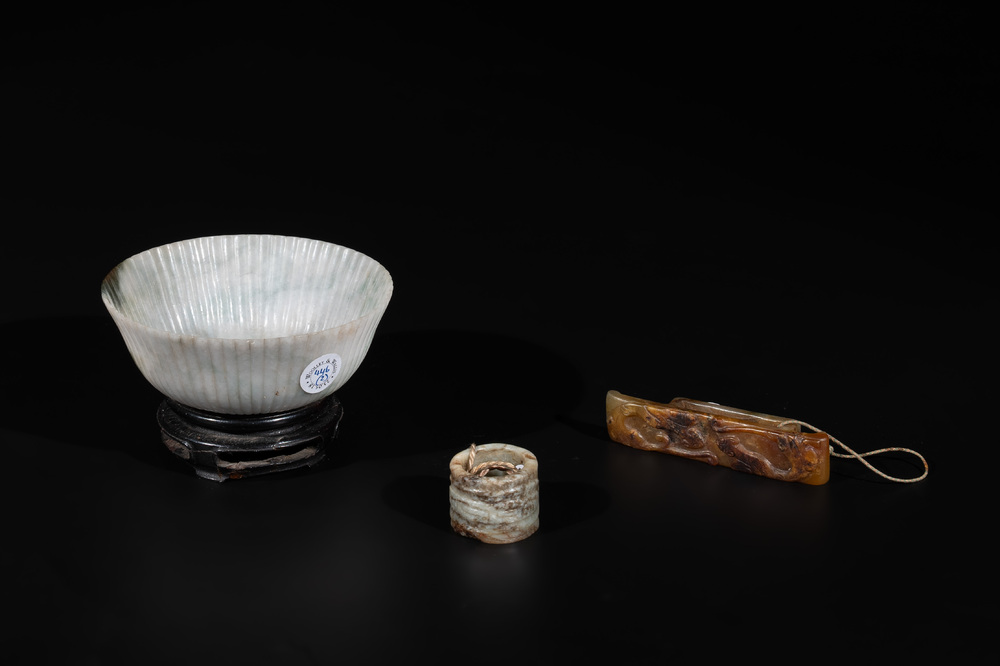 A Chinese jade 'chrysanthemum' bowl, an archer's ring and a belt hook, Ming/Qing