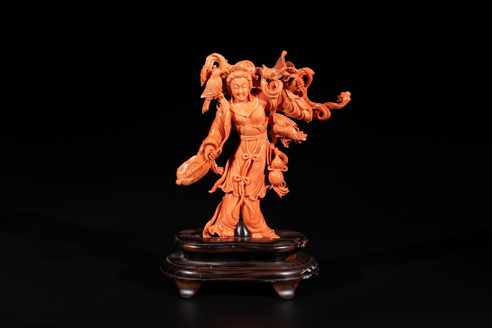 A Chinese red coral Xiwangmu on wooden stand, 19/20th C.