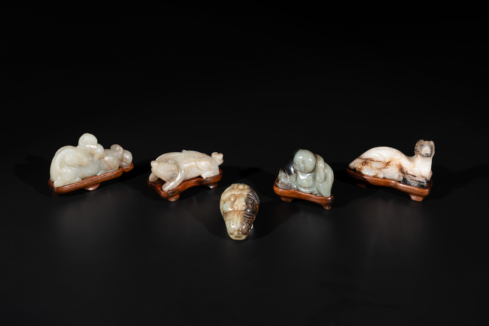 Five Chinese jade carvings with four wooden stands, 19th C.