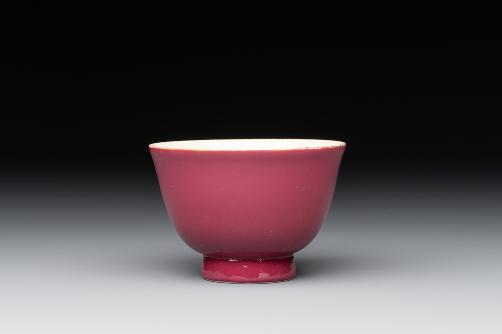 A fine Chinese ruby-ground famille rose 'magnolia' cup, Qianlong mark and of the period
