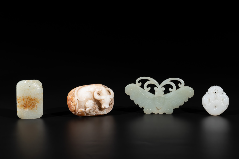Four Chinese white, celadon and russet jade pendants, Qing/Republic