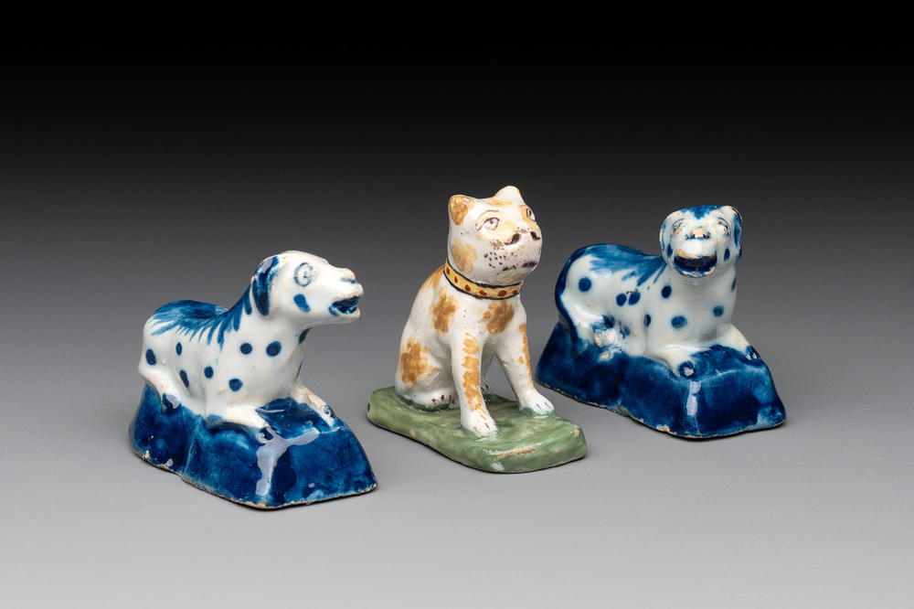 A pair of blue and white Dutch Delft miniature models of dogs and a polychrome dog, 18th C.
