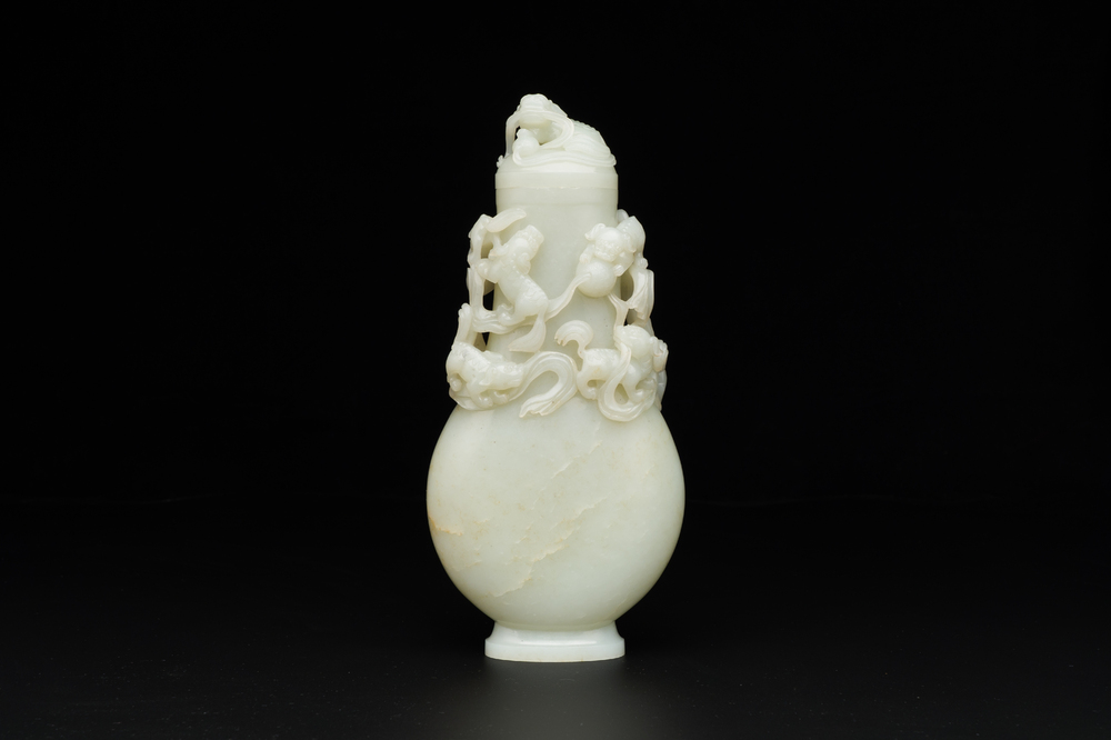 A fine Chinese white jade 'Buddhist lions' vase and cover, Qing