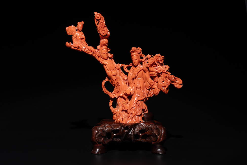 A Chinese red coral group of goddesses on wooden stand, 19/20th C.