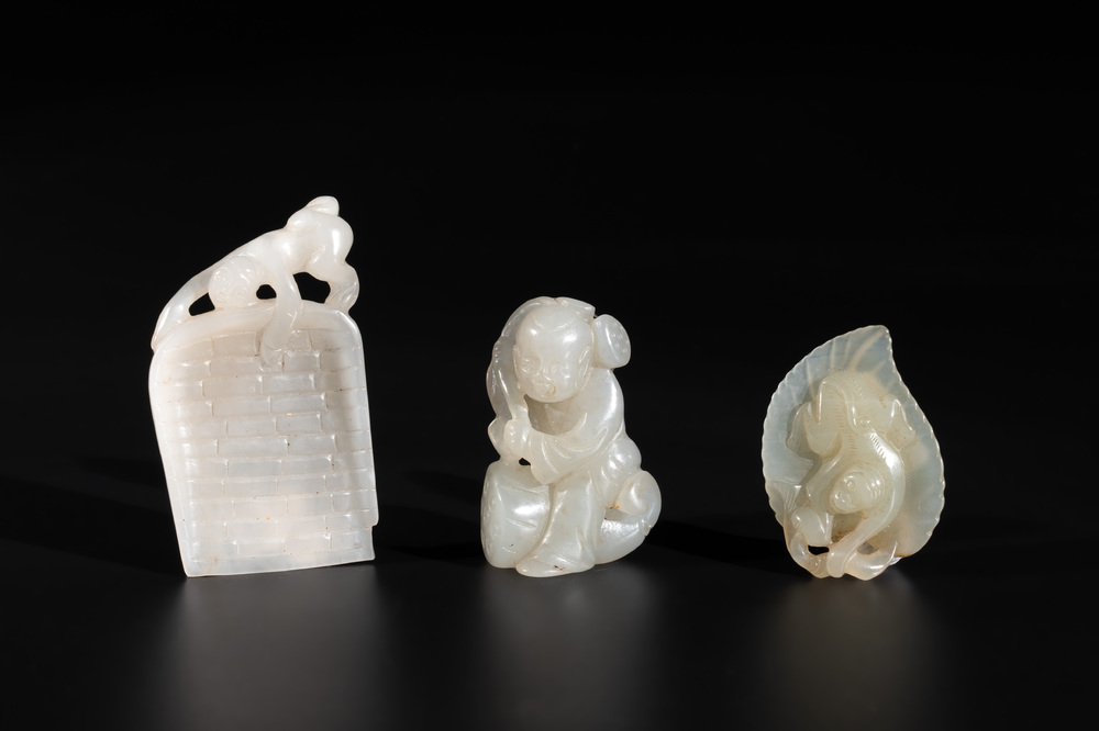 Three Chinese white and celadon jade carvings of a boy and two monkeys, 19th C.