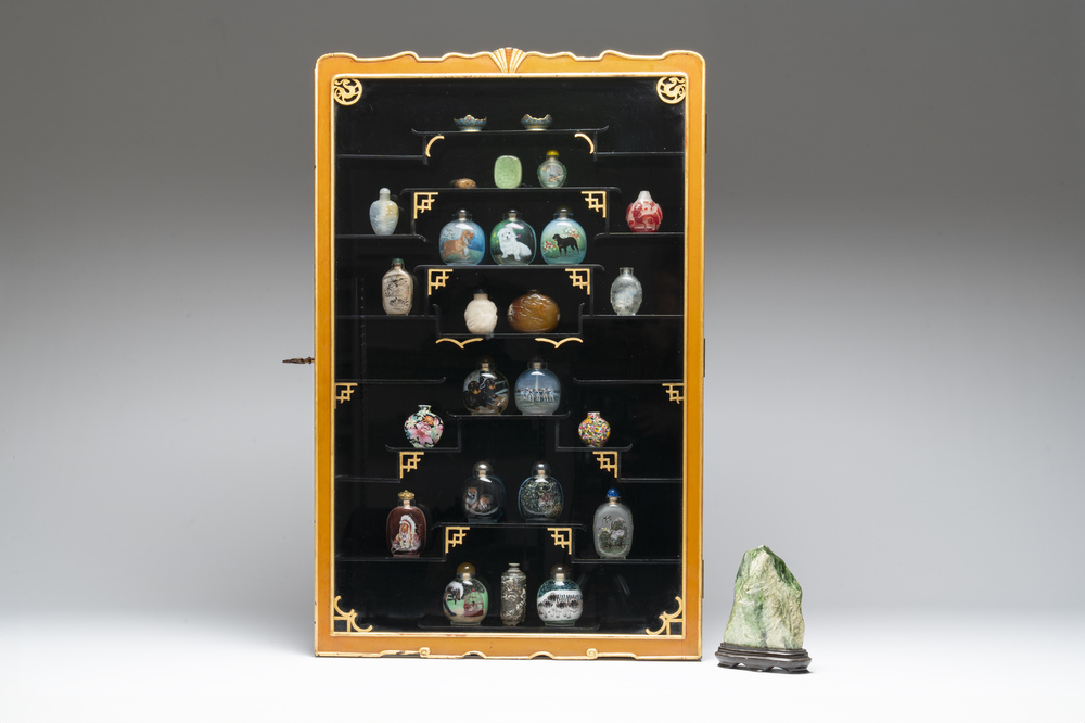 A Chinese gilt-lacquered wall display cabinet and a collection of various snuff bottles, stands and carvings, 20th C.