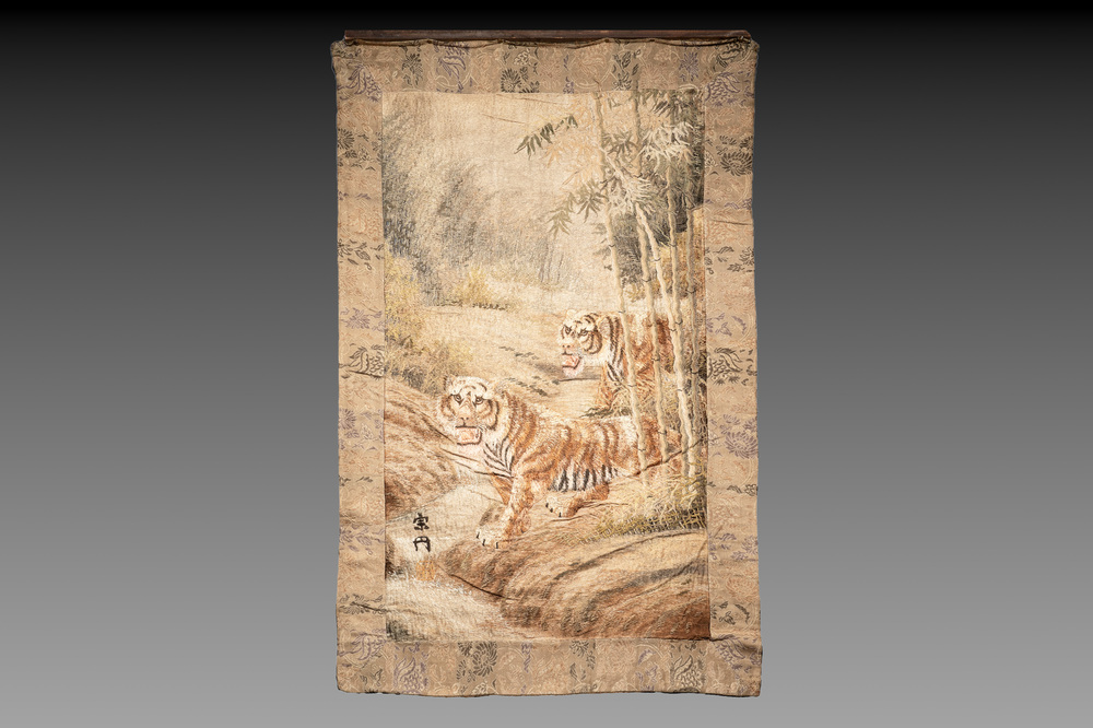 A Japanese embroidered silk wall tapestry with two tigers, Meiji, 19th C.