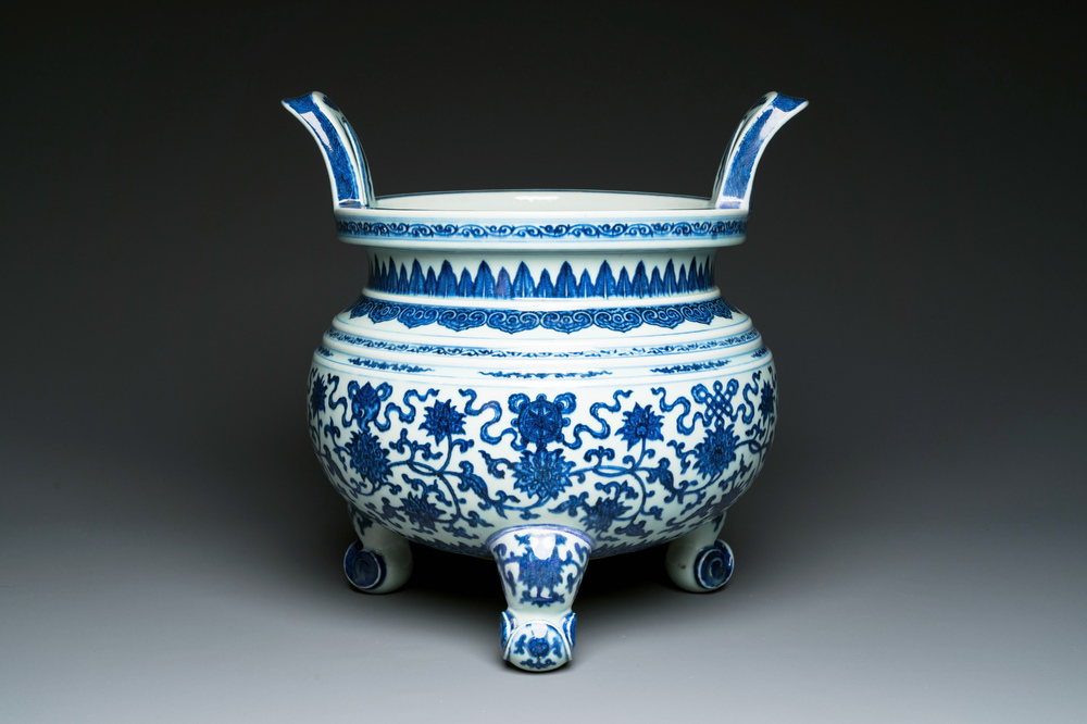 A large Chinese blue and white 'bajixiang' and 'lotus scrolls' tripod censer, Qianlong