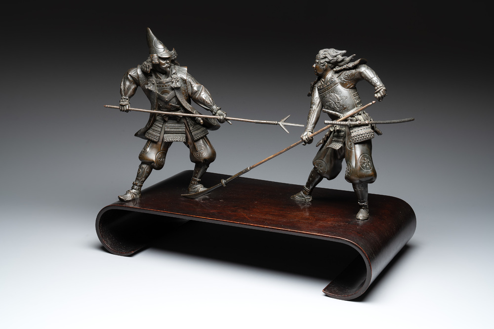 A fine pair of Japanese bronze warriors mounted on a wooden stand, Meiji/Taisho, 19/20th C.