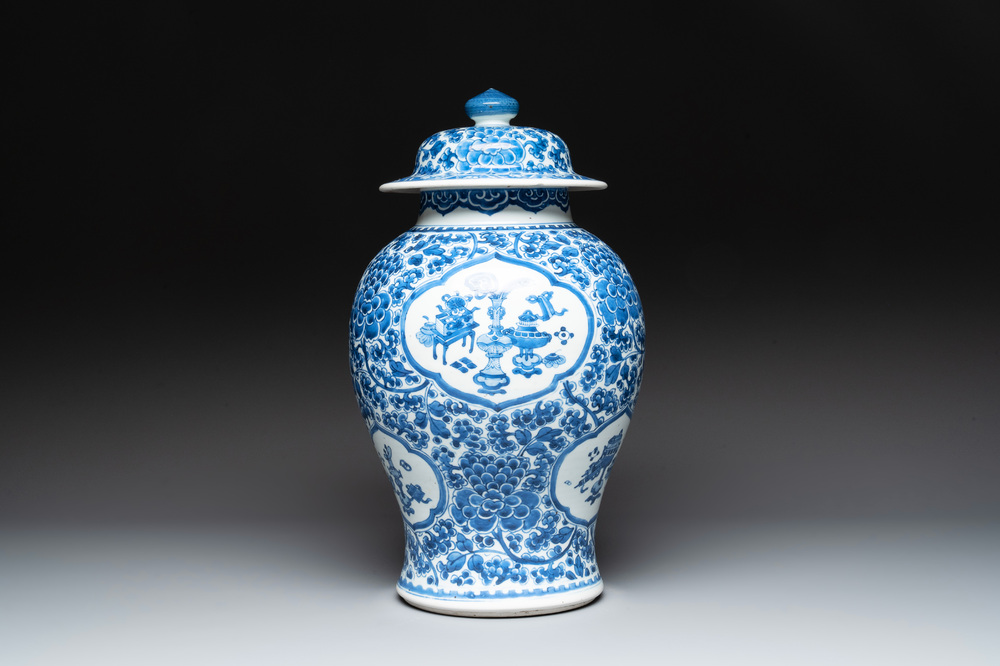 A Chinese blue and white 'antiquities and peony scrolls' vase and cover, Kangxi