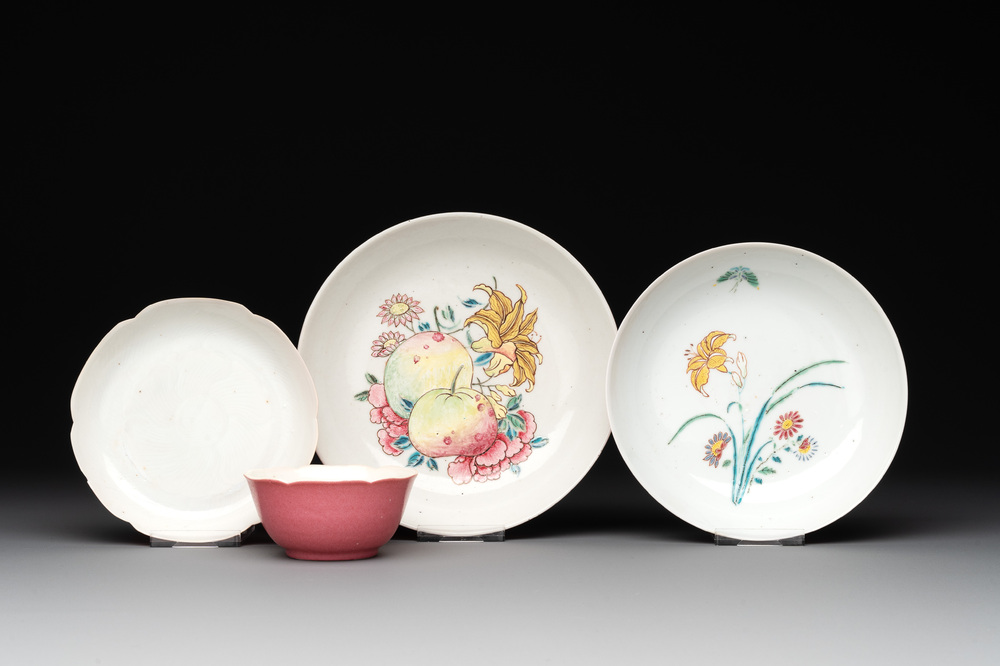 Three Chinese ruby-ground famille rose plates and a cup, 19th C.