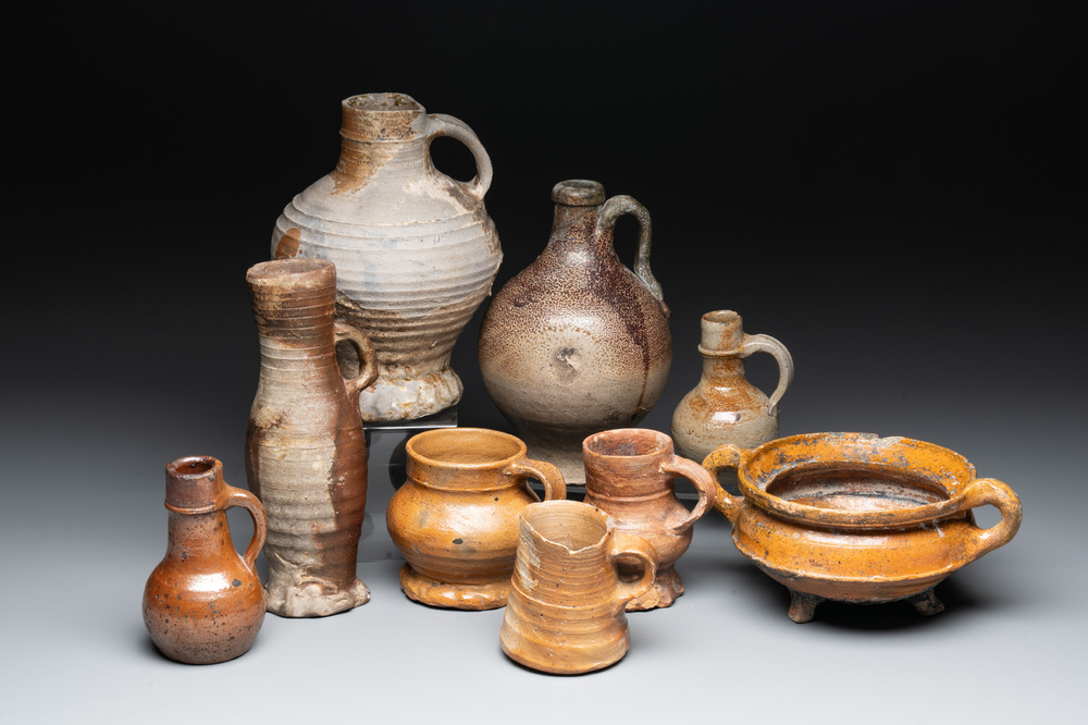 Eight stoneware jugs and mugs, and a glazed pottery vessel, Germany and The Netherlands, 16/17th C.