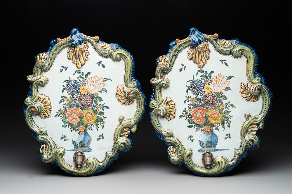 A pair of polychrome Dutch Delft plaques mounted as wall sconces with silver mounts, 18th C.