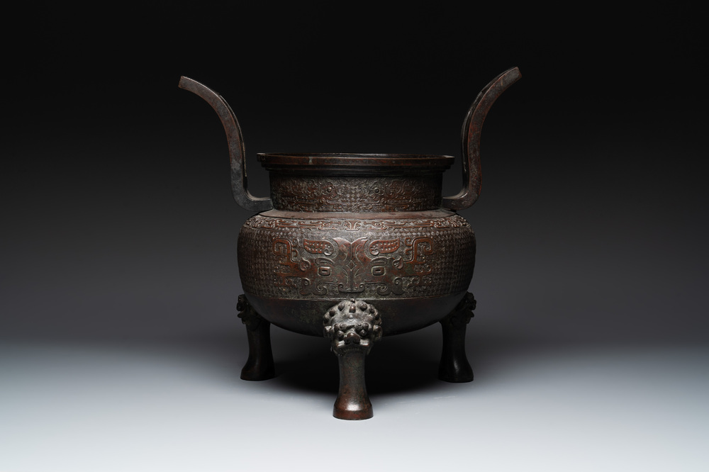 A large Chinese bronze archaistic 'taotie' tripod censer, 18th C.