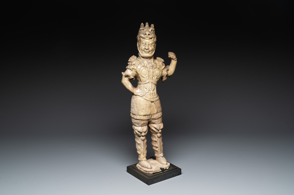 A Chinese stoneware cream-glazed sculpture of a warrior, possibly Tang