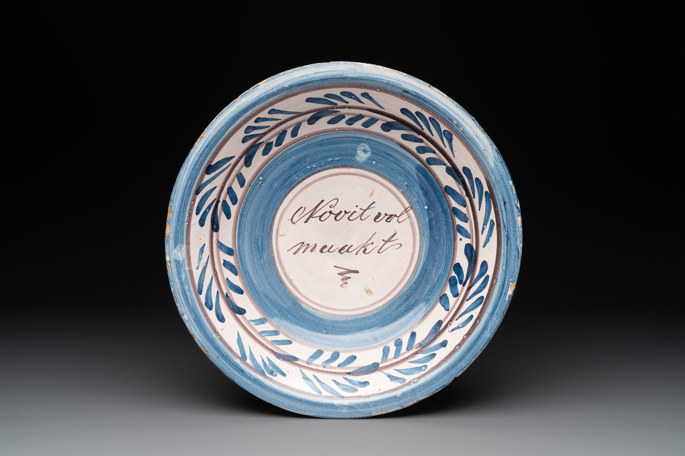 A proverbial blue, white and manganese dish, Makkum, Friesland, 1st half 19th C.