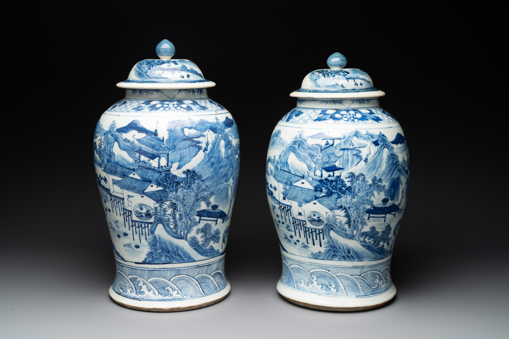 A near pair of Chinese blue and white 'landscape' vases and covers, 19th C.