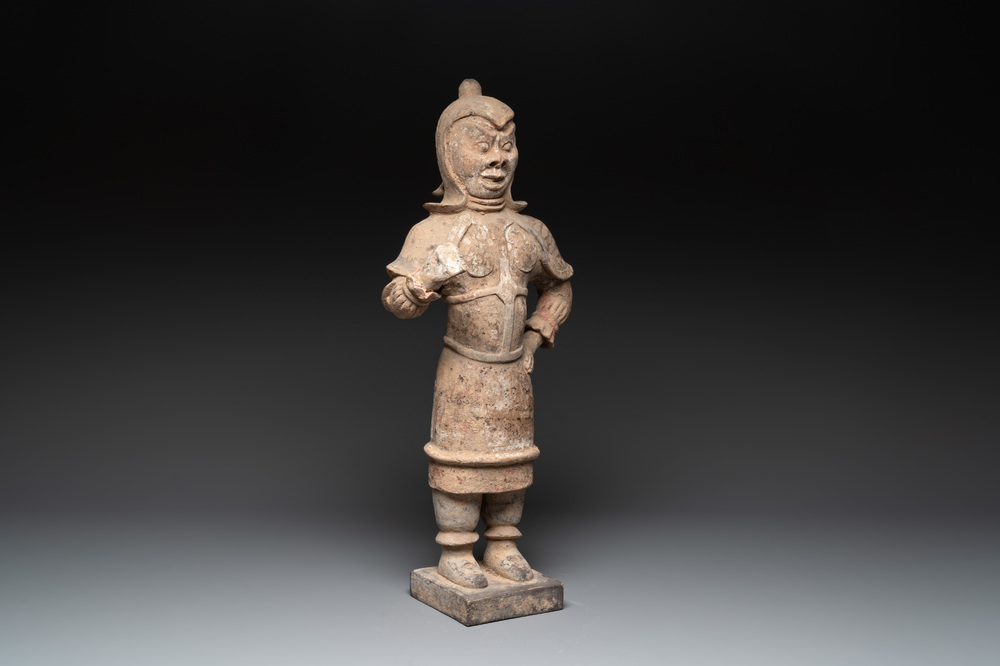 A large Chinese painted pottery figure of a standing guardian, Tang