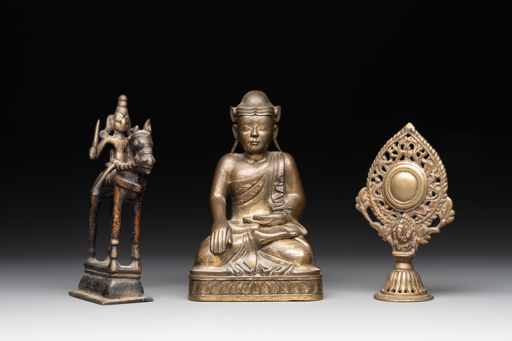A Burmese gilt bronze Buddha, an Indian bronze Shiva on horseback and and a Nepalese Melong ritual mirror with Ganesh, 18/19th C.