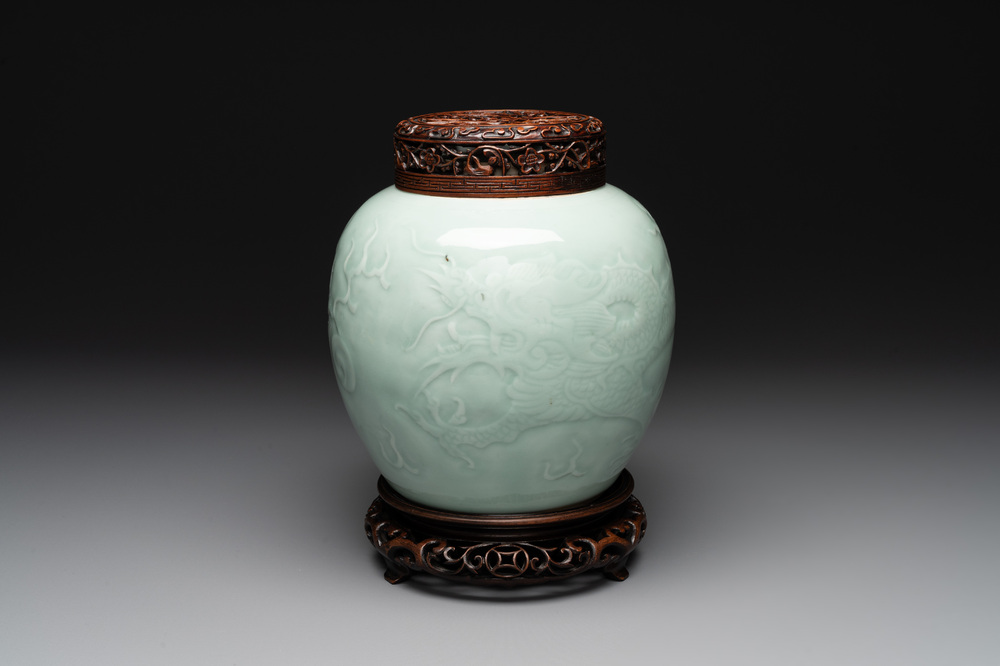 A Chinese celadon-glazed 'dragon' jar with reticulated wooden cover and stand, Qianlong