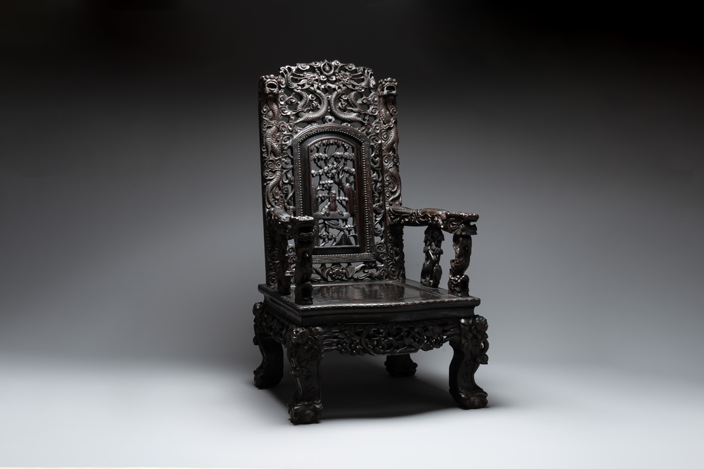 A Chinese richly carved and lacquered hongmu armchair, Canton, 19th C.