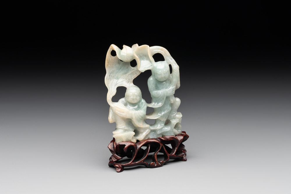 A Chinese jade 'He He Er Xian' group on wooden stand, 19th C.