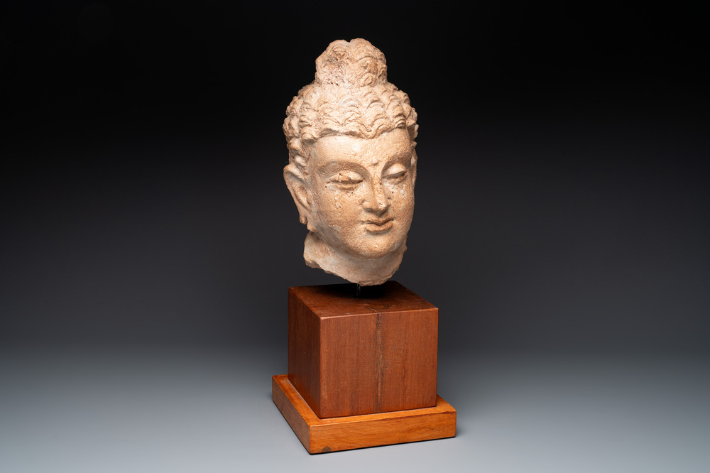 A large terracotta head of Buddha Shayamuni, Gandhara region, Kushan period, 4/5th C.