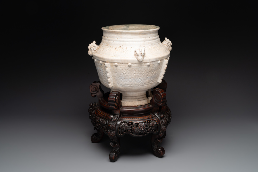 A Chinese archaistic white-glazed vase on wooden stand, Qing