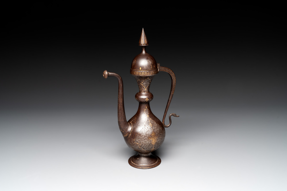 A Persian steel engraved gilt-decorated pear-shaped ewer and cover with floral design, Qajar, 19th C.