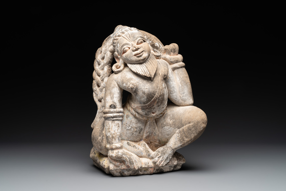 An Indian polychromed stone sculpture of a deity, 18/19th C.