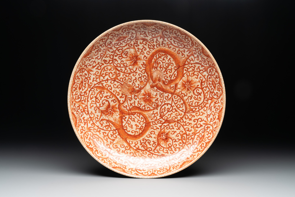 A Chinese iron-red-decorated crackle-glazed  'chilong and lotus scroll' plate, Jiajing mark, 19th C.