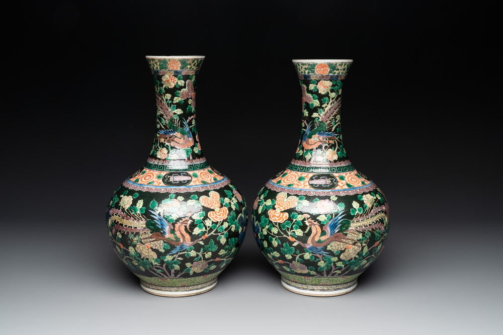 A pair of Chinese famille verte black-ground 'phoenix' bottle vases, Qianlong mark, 19th C.