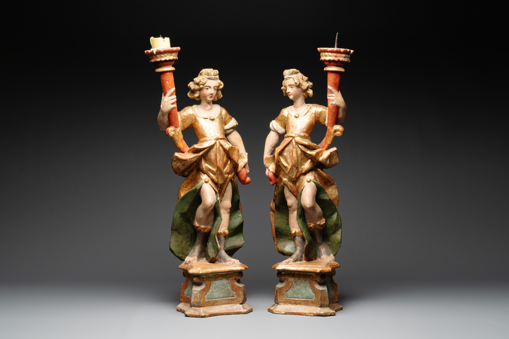 A pair of gilt and polychromed wooden angel-form candlesticks, Germany, 18/19th C.