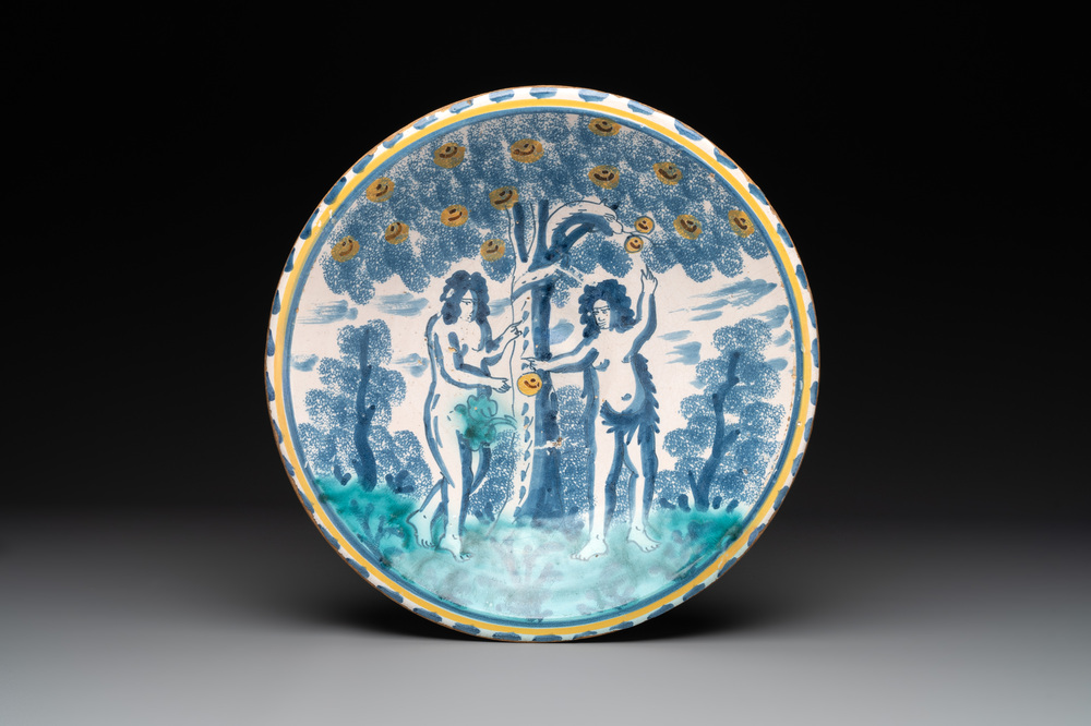 A polychrome English Delftware 'Adam and Eve' blue dash border dish, 17th C.