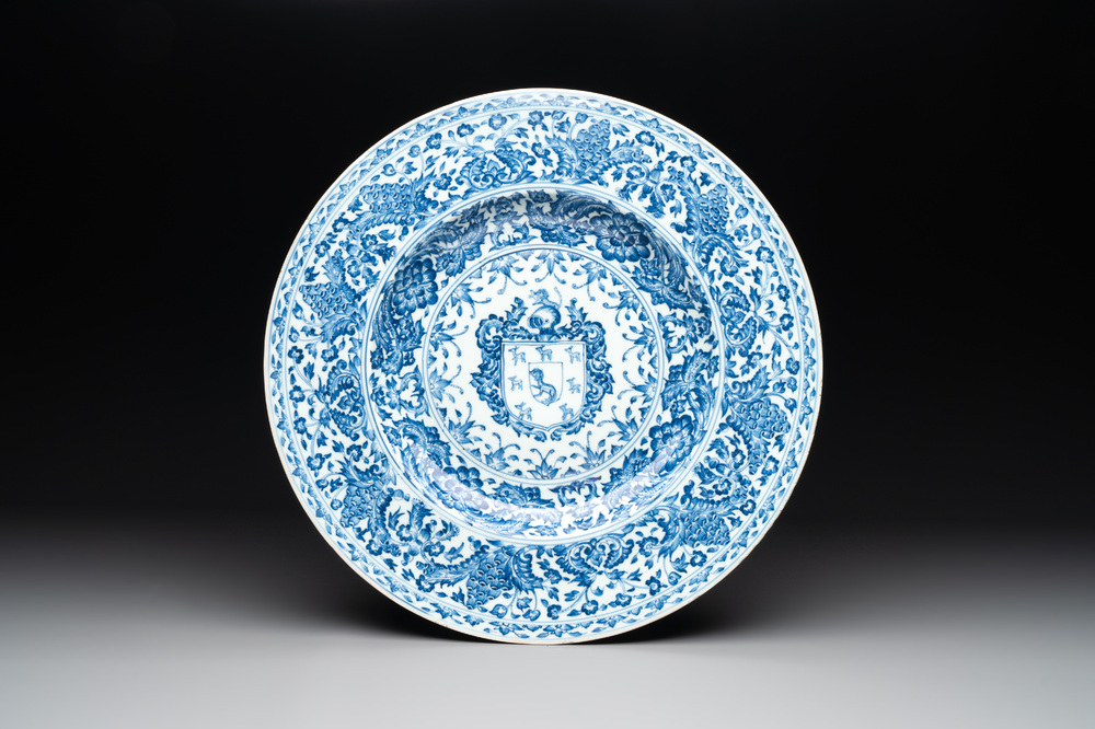 A large Chinese blue and white armorial dish with the arms of the Coelho family, Kangxi
