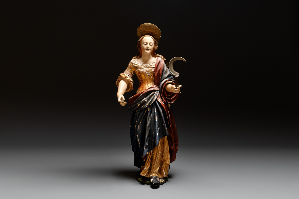 A large gilt and polychromed wooden sculpture of a female saint with a sickle, Germany, 18th C.