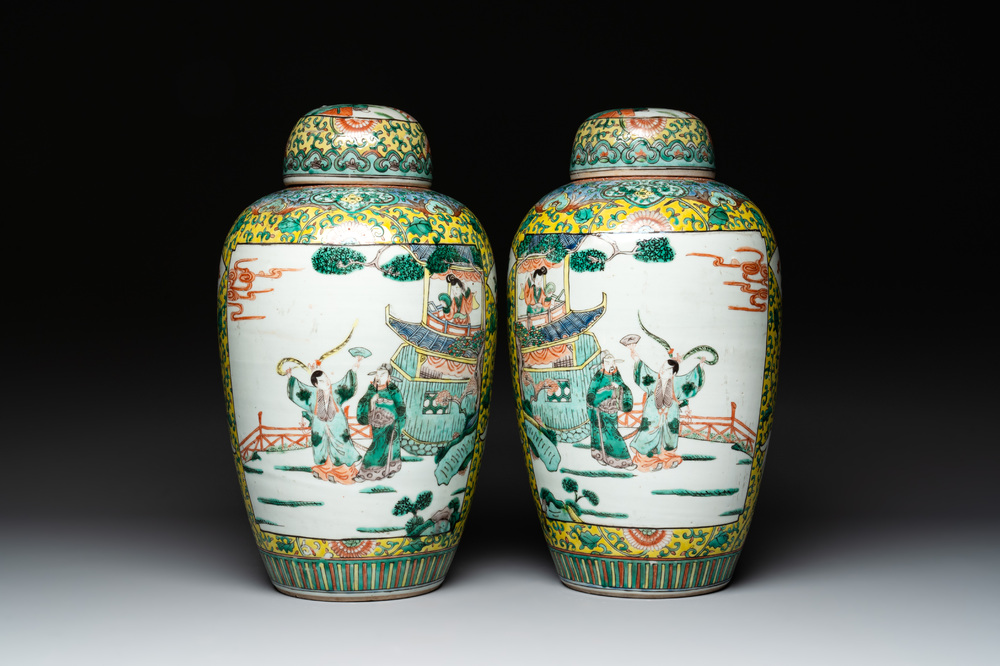 A pair of Chinese famille verte yellow-ground vases and covers with narrative design, 19th C.