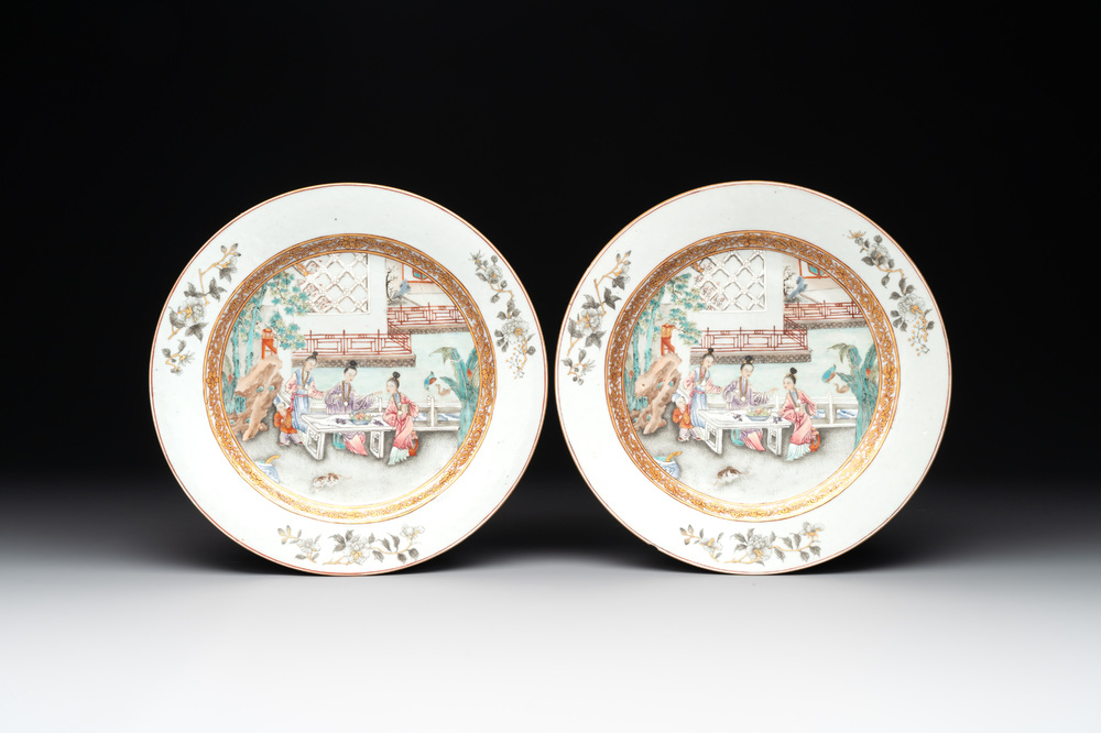 A fine pair of Chinese Canton famille rose 'ladies in the garden' plates, Yongzheng/Qianlong