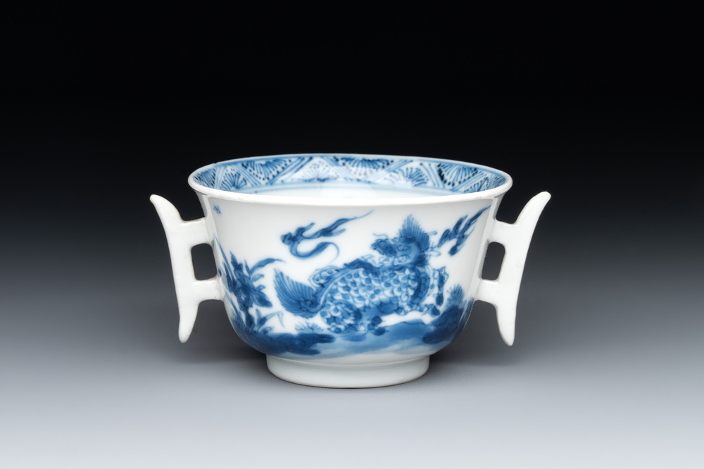 A rare Chinese blue and white 'qilin and phoenix' cup with handles, Kangxi