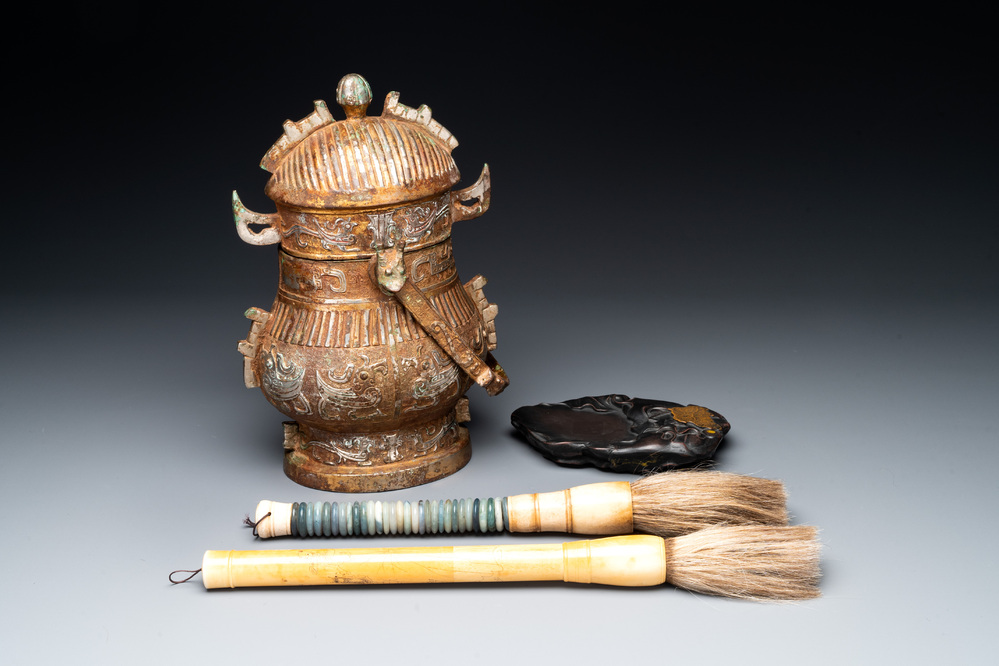 A Chinese archaistic bronze 'you 卣' vessel and cover, an inkstone and two calligraphy brushes, 20th C.