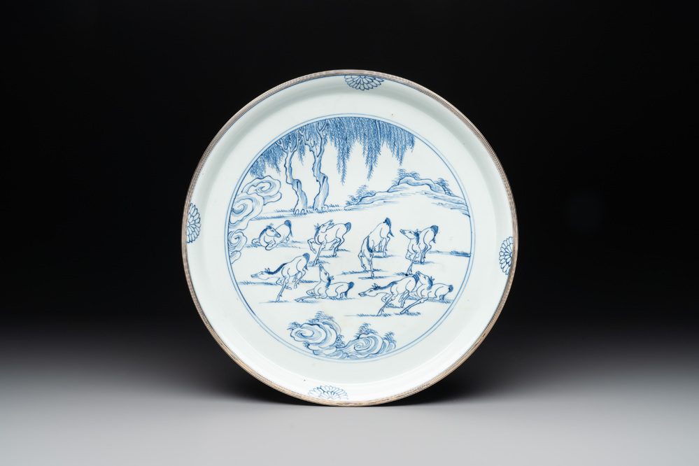 A rare Chinese silver-mounted blue and white 'Eight horses of Mu Wang' dish, Kangxi