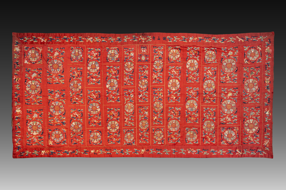A Chinese red-ground embroidered silk 'bajixiang' panel, Tie Shan Si 鐵山寺 mark, 19th C.