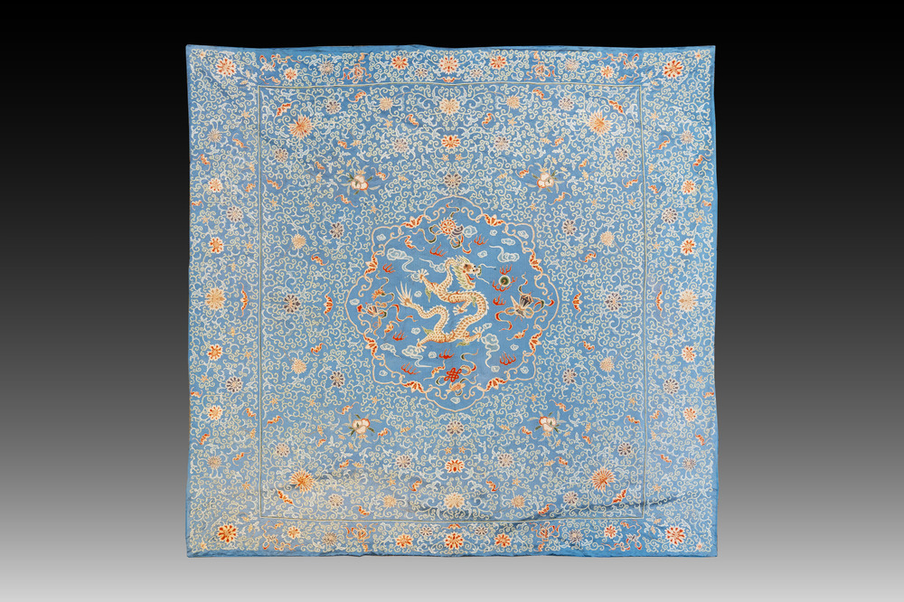 A Chinese blue-ground embroidered silk panel with a dragon among bajixiang, 19th C.