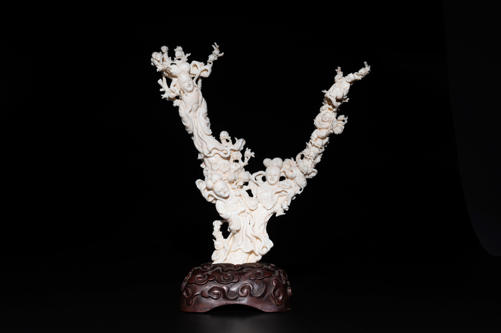 A Chinese white coral group of goddesses on wooden stand, 19/20th C.