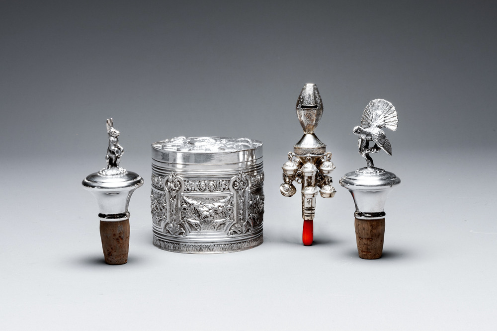 Two silver bottle stoppers, a tobacco box and a baby rattle with red coral teether, Germany, 19/20th C.