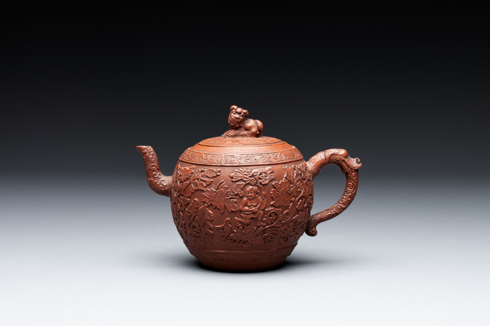 A Chinese Yixing stoneware teapot with boys among flower scrolls, Kangxi